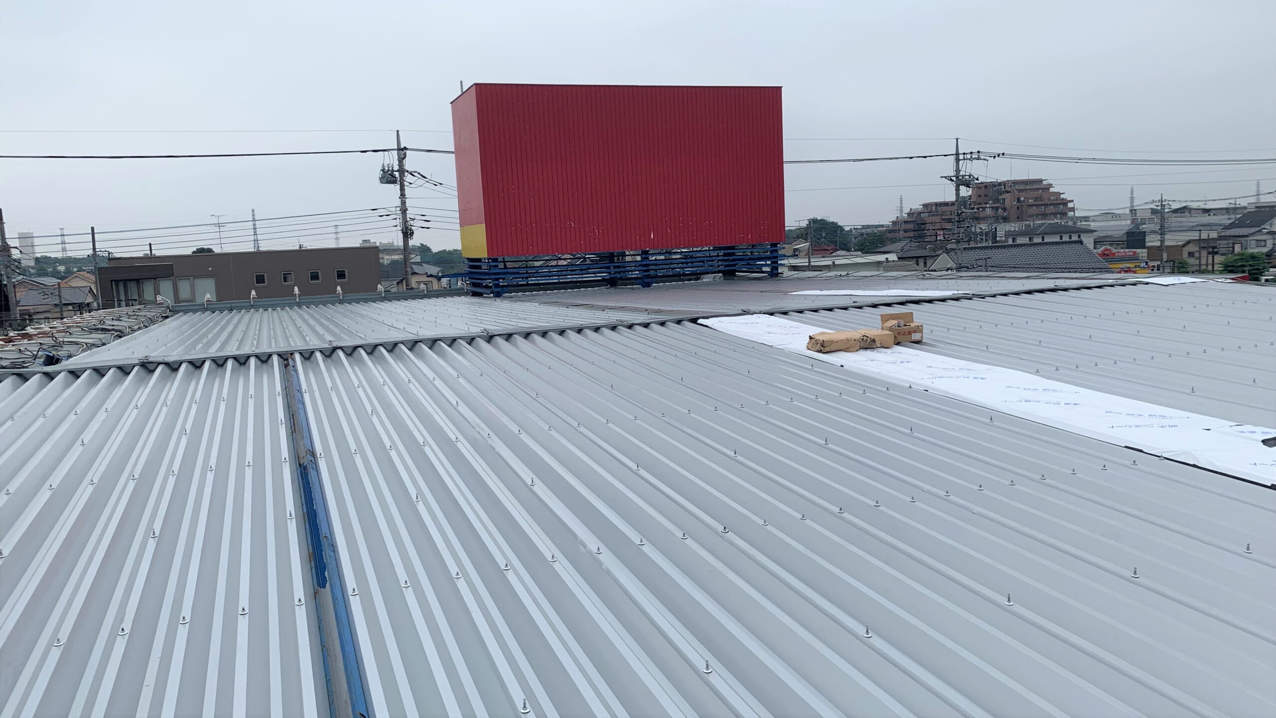 新しい折板屋根を取り付けている様子